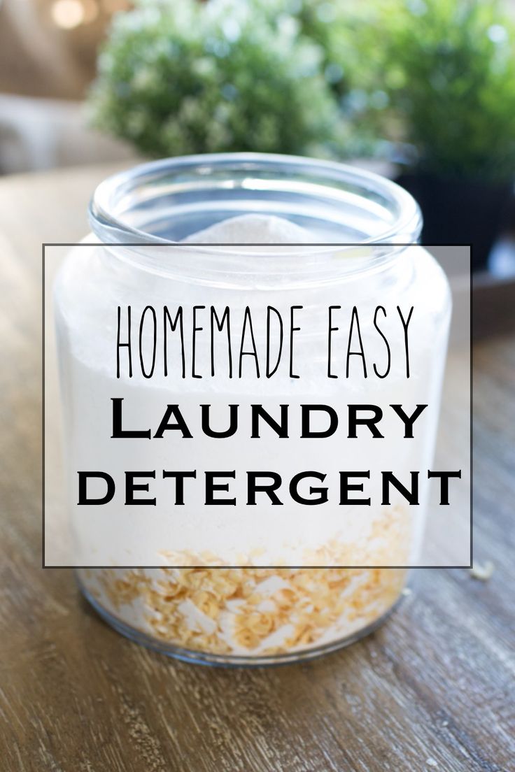 homemade easy laundry deterant in a glass jar on a wooden table next to a potted plant