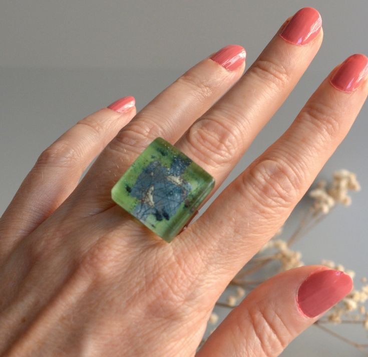 Chunky glass ring in lime green and blue colors. A unique statement piece infusing you with confidence. Handmade glass in lime green and blue colors, with a hint of black. The decor is hand painted and trapped inside the glass creating a fascinating depth effect. The ring band is adjustable size so you can adapt it to any finger, which makes it perfect for gift. This ring has an amazing tiny bubble landscape inside which is magnified by the thickness of the glass. It has softly rounded corners a Handmade Modern Green Jewelry, Green Handmade Modern Jewelry, Modern Handmade Green Jewelry, Modern Green Handmade Jewelry, Green Glass Jewelry Gift, Green Glass Jewelry As Gift, Green Glass Jewelry As A Gift, Unique Green Resin Ring, Unique Green Resin Rings