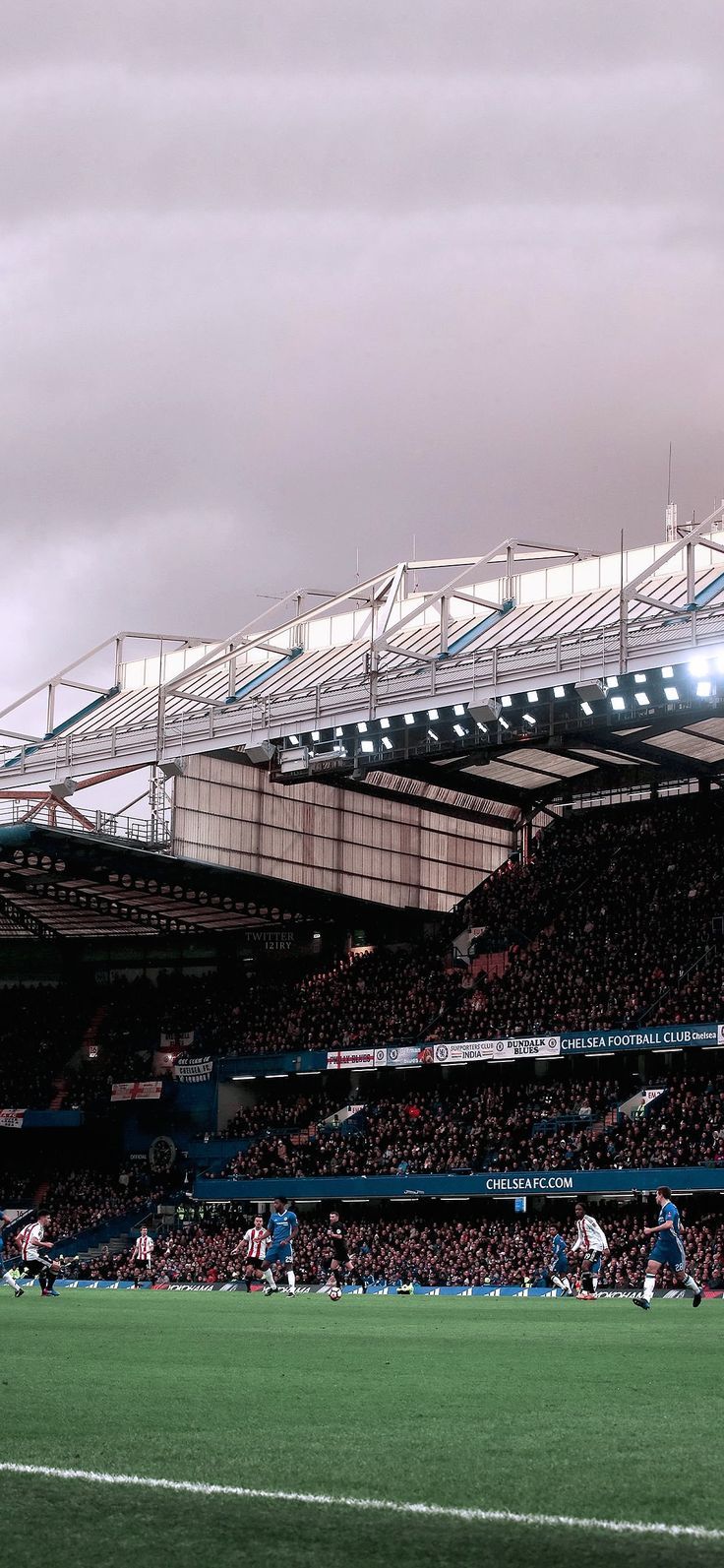 an empty stadium filled with people playing soccer