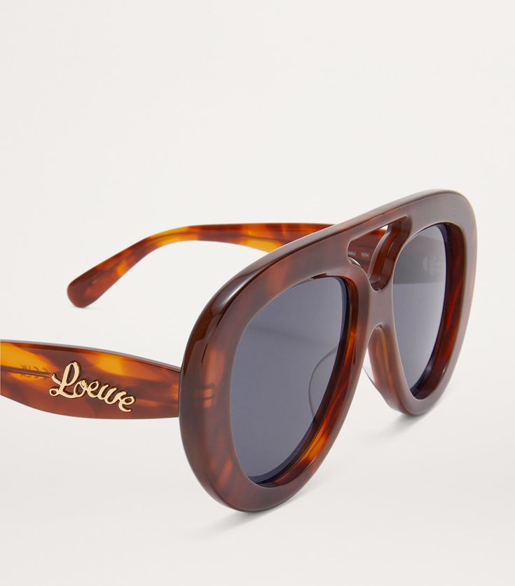 Find LOEWE Round Spoiler Aviator Sunglasses on Editorialist. The Round Spoiler Aviator sunglasses from loewe are for those who want to stand out while standing firmly on the ground. The curved profile lends a '60s feel to the glossy frames, while tinted lenses add an air of mystery. Loewe Sunglasses, Tom Ford Sunglasses, Trending Sunglasses, Fine Watches, Trainer Boots, Shoes Heels Pumps, Sunglasses & Glasses, Boots Knee, Luggage Accessories