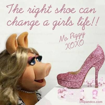 the miss piggy is looking at her high heel shoe