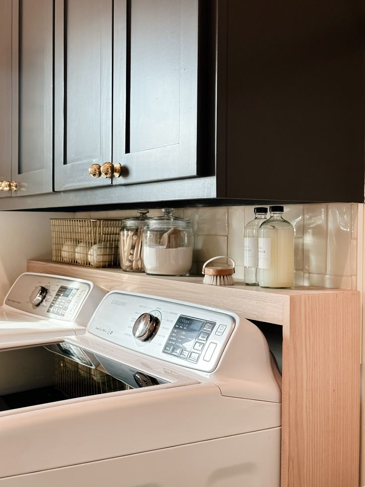 a washer and dryer sitting in a kitchen next to each other on top of a counter