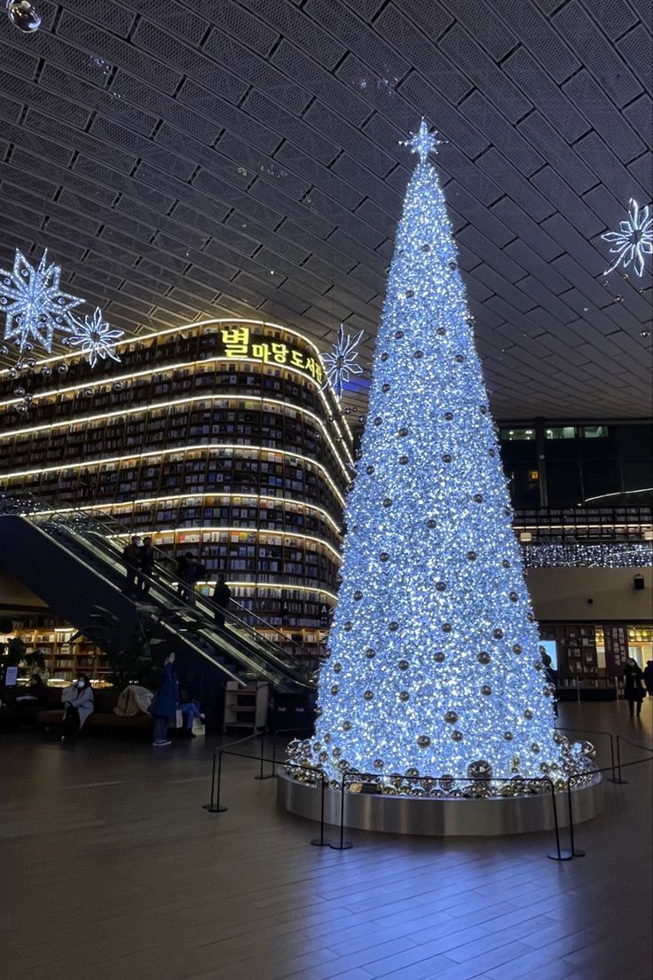 a large christmas tree sitting in the middle of a lobby