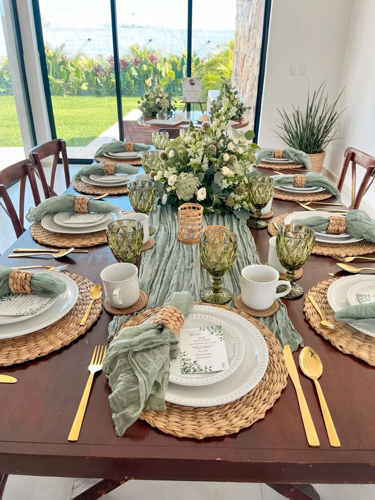 the table is set with plates and place settings