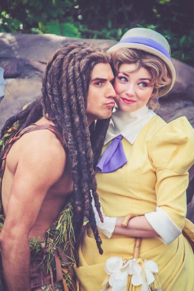 a man and woman dressed in costumes standing next to each other with dreadlocks