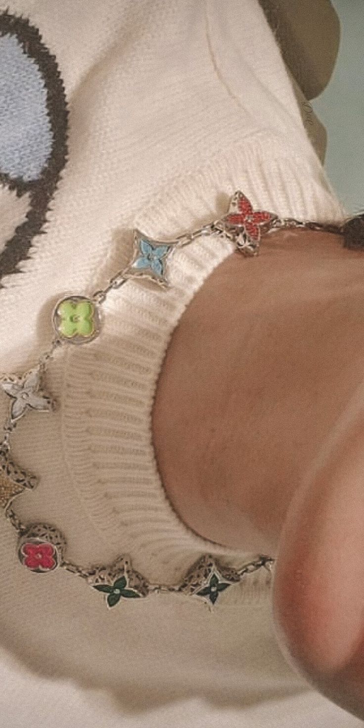 a close up of a person wearing a shirt with charms on it's chest