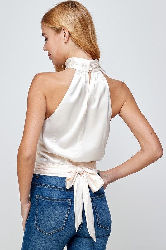 Our Viva Satin Top features a halter neckline, pleated mock neck with button closure at back, and tie sash at waist (could be tied to the front or back). Mock Neck Halter Top Satin Fabric 95% Polyester, 5% Spandex White Satin Top, Halter Neck Blouses, Neck Halter Top, Stretch Satin Fabric, Top Satin, Love Jeans, Satin Top, Stretch Satin, Best Jeans