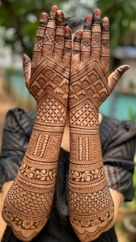 a woman with her hands covered in henna