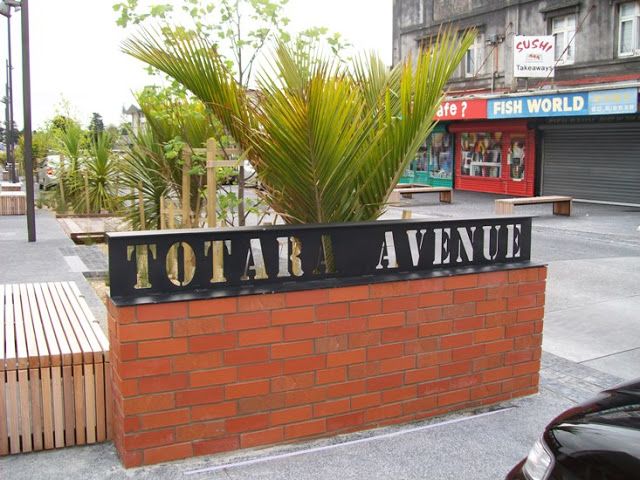 there is a sign that says tofara avenue in front of a brick wall