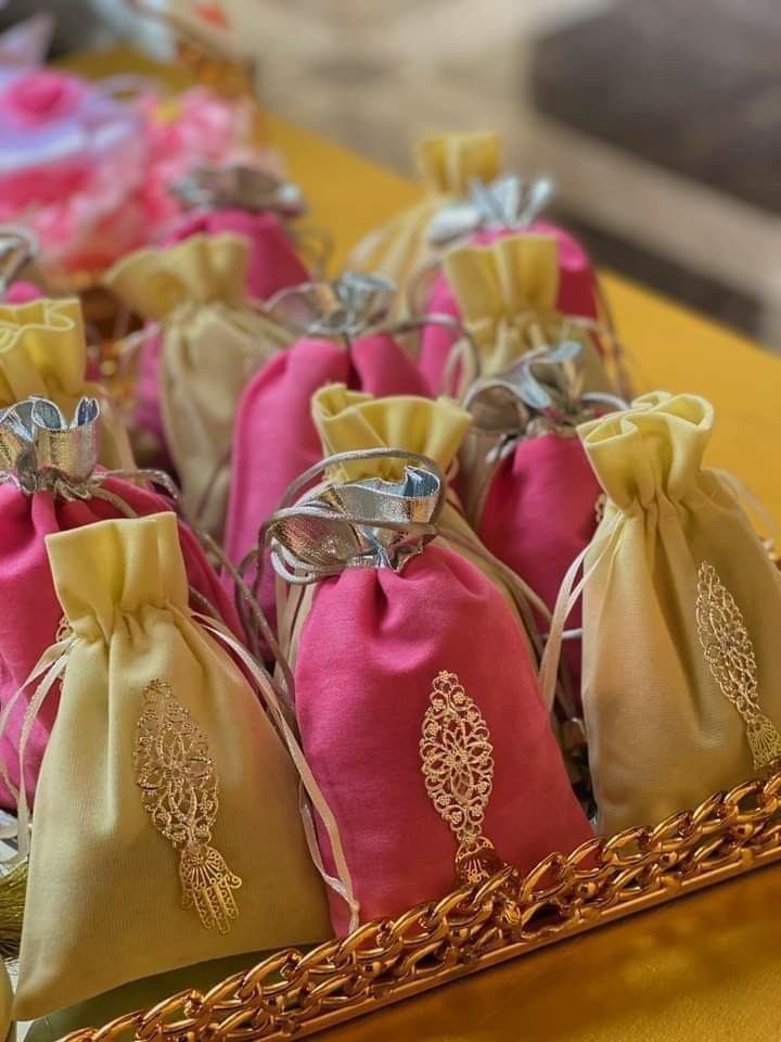 several bags with ties are sitting in a basket on the table next to each other