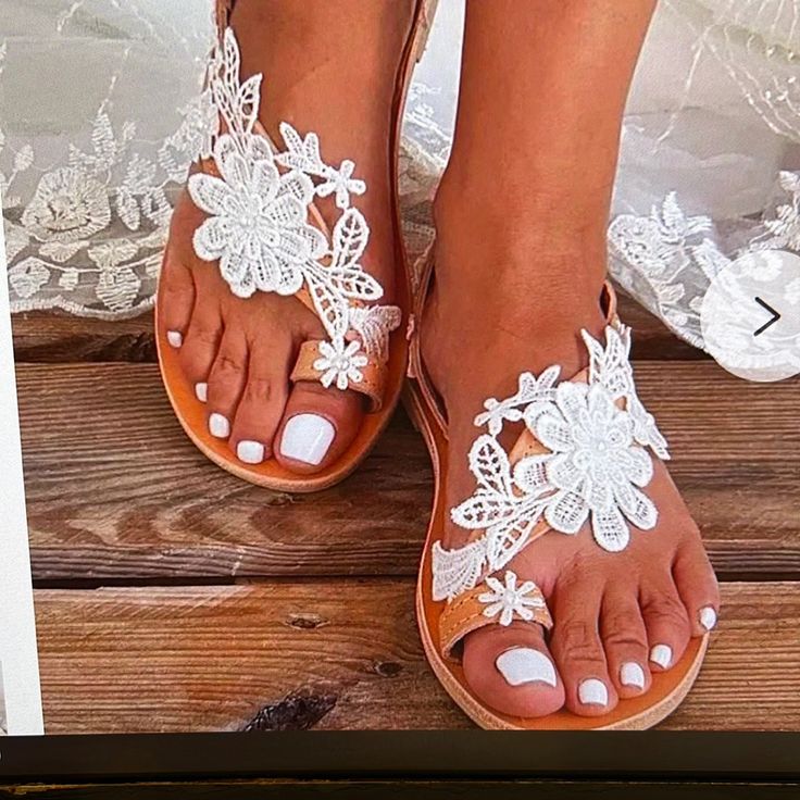 Gorgeous White Lace Flower Flip Flop Sandals White T-strap Sandals For Beach Season, White T-strap Sandals With Round Toe For Vacation, White Round Toe T-strap Sandals For Vacation, White Round-toe T-strap Sandals For Vacation, White Closed Toe T-strap Sandals For Spring, Elegant Flat Heel Sandals For Beach Season, Spring Beach T-strap Open Toe Sandals, White Flat Heel Sandals For Beach Season, Spring Beach Open Toe T-strap Sandals