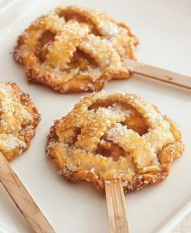 three pastries on a white plate with wooden skewers