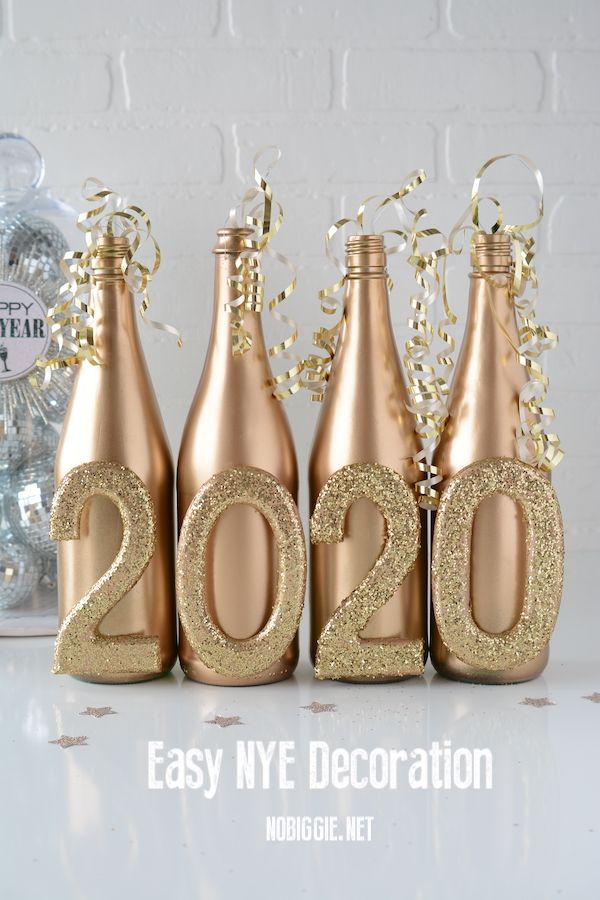 three champagne bottles with gold numbers on them