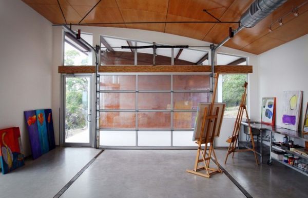 an artist's easel is standing in front of a large open garage door