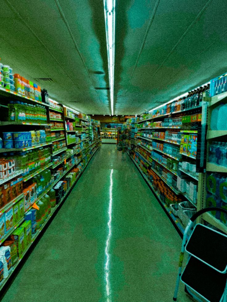 an empty grocery store aisle filled with lots of food