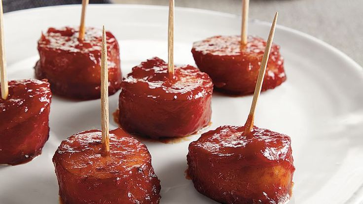 small appetizers with toothpicks on a white plate