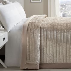 a white bed sitting next to a window in a bedroom