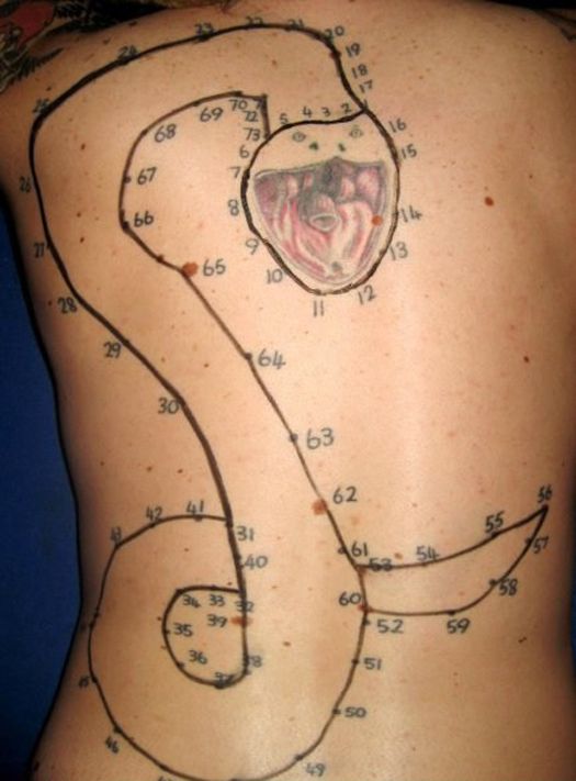 the back of a woman's body with an electrical diagram on her stomach and some wires attached to it