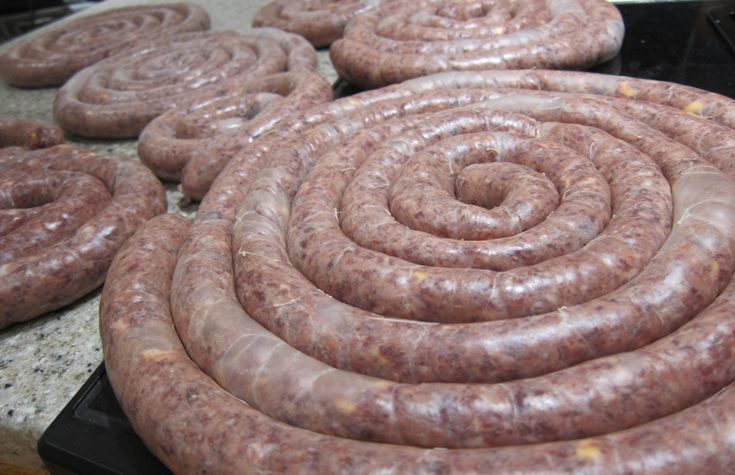 there are many sausages on the counter ready to be cooked in the oven for consumption