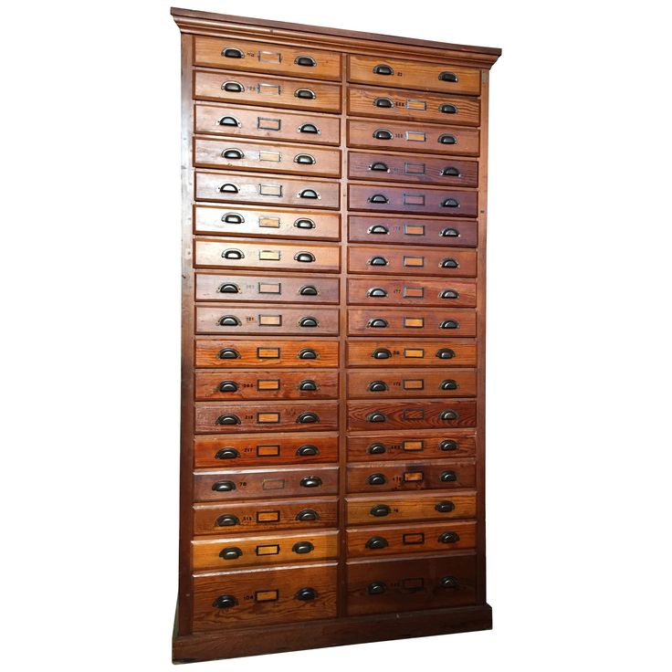 an old wooden filing cabinet with many drawers