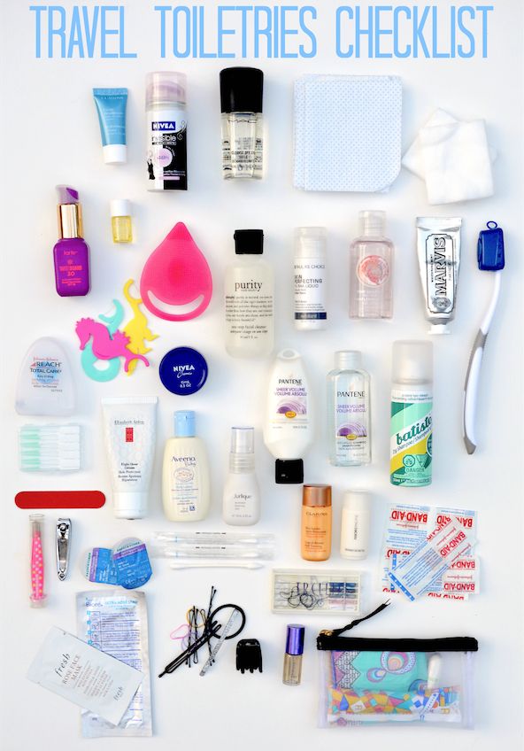 the contents of a travel toiletries checklist laid out on a white surface with text overlay