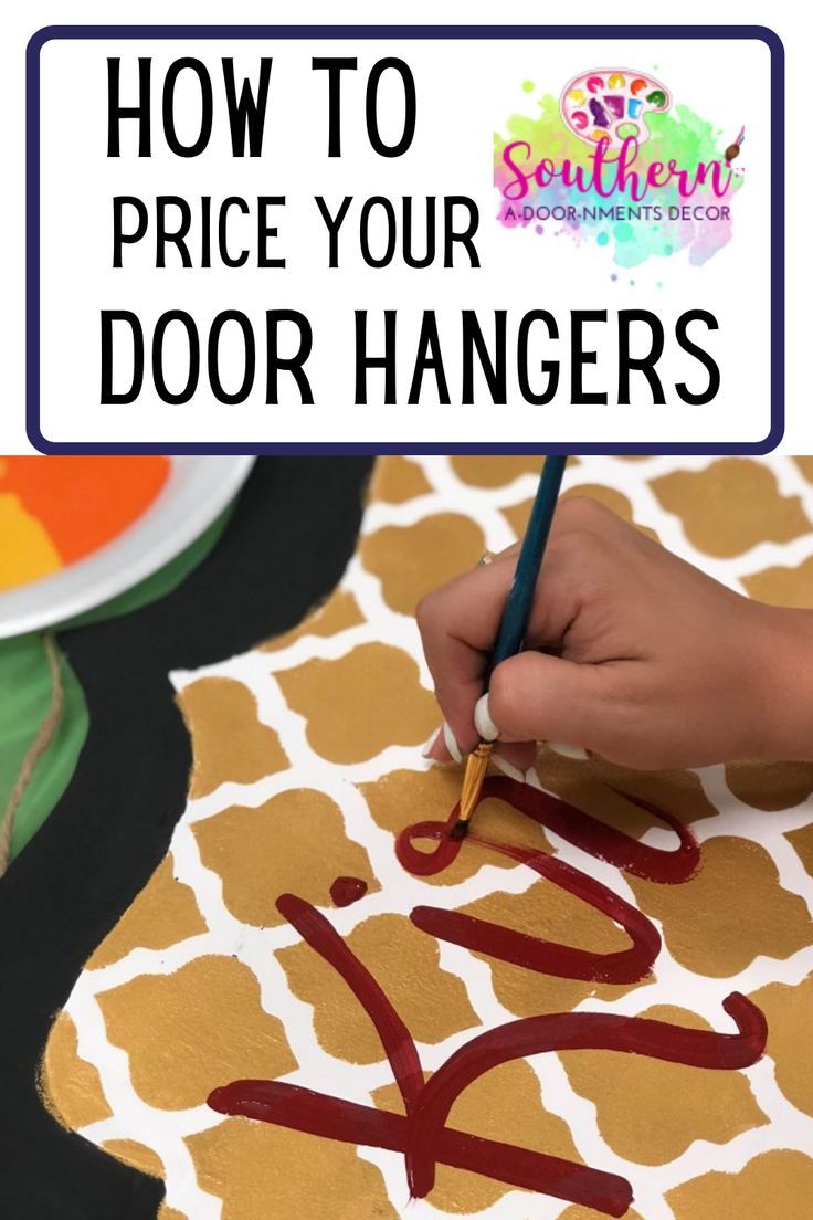 someone is painting the letters on a door hanger