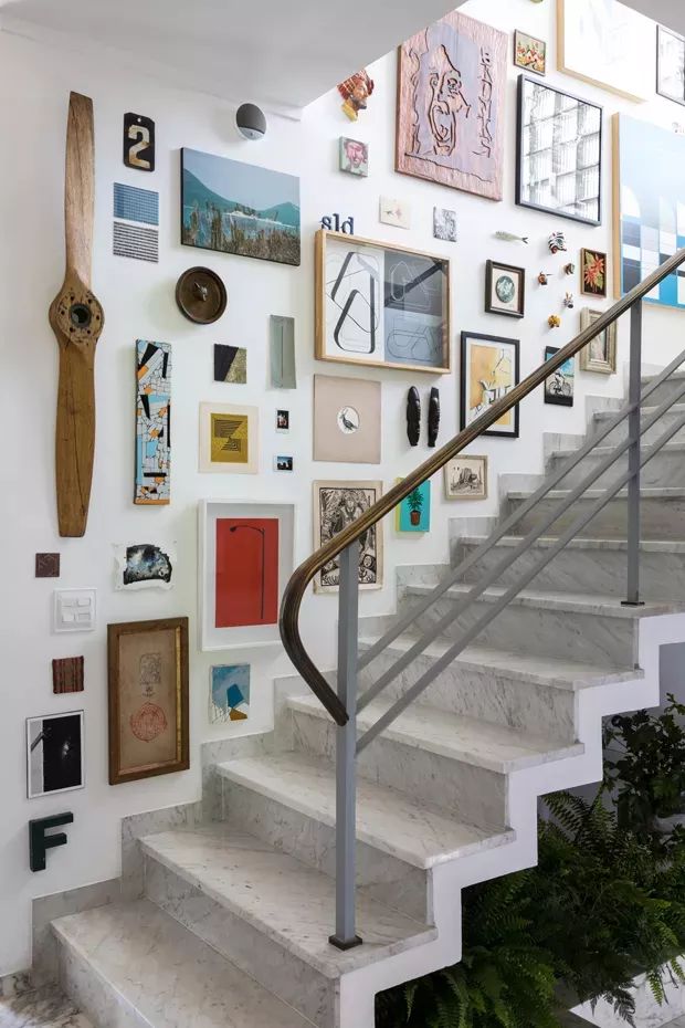 a staircase with many pictures on the wall