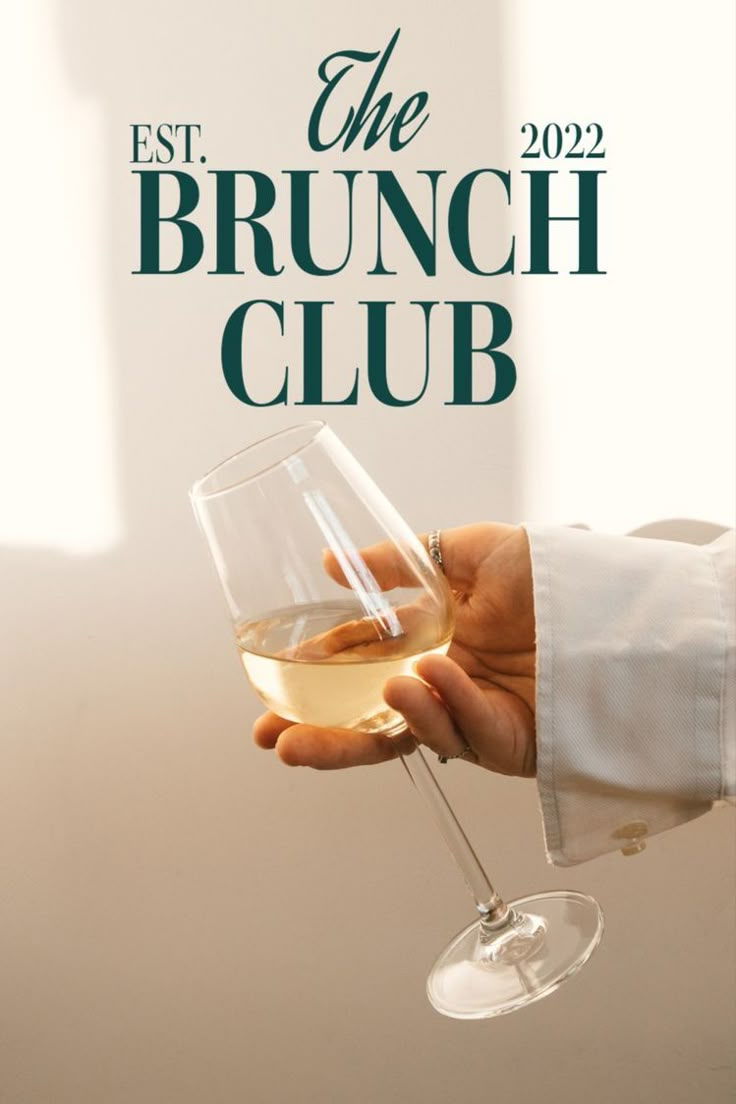 a person holding a wine glass with the brunch club logo in front of them