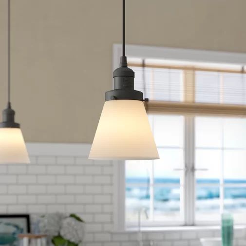 two lights hanging from the ceiling in a kitchen