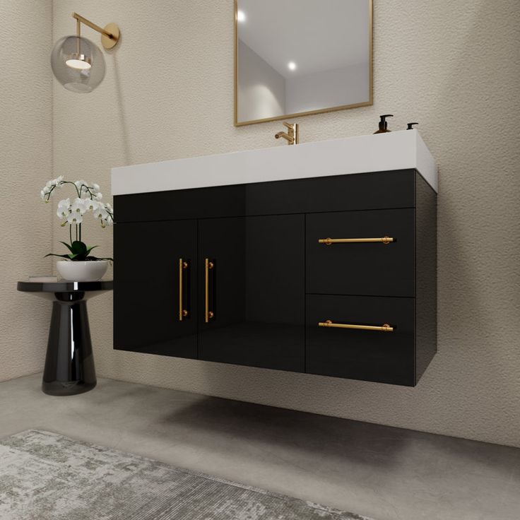 a black and white bathroom with gold handles on the cabinet doors, mirror over the sink