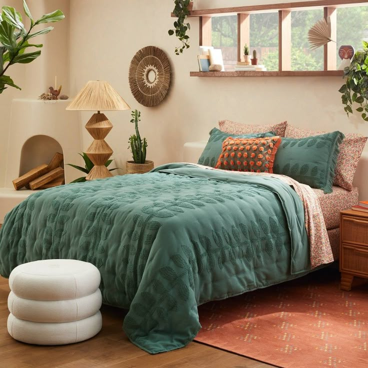 a bed room with a neatly made bed and lots of plants