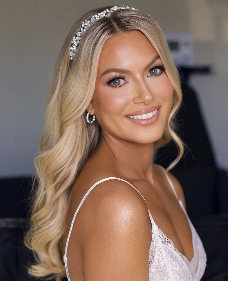 a woman with blonde hair wearing a tiara