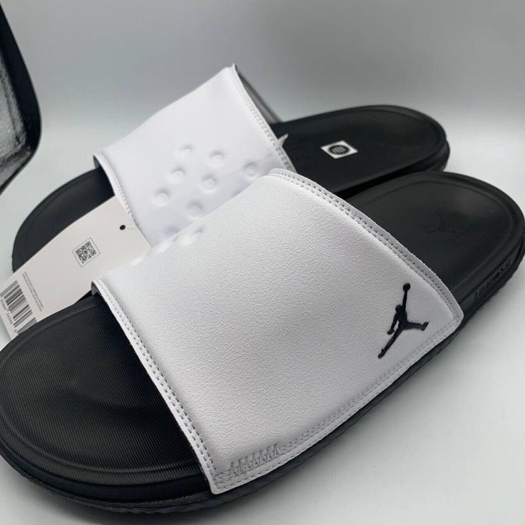 Air Jordan Play Slide White/Black Sandals Modern White Sport Sandals With Round Toe, Sporty White Sandals For Vacation, Modern White Open Toe Sport Sandals, White Sport Sandals With Textured Footbed For Vacation, White Non-slip Open Toe Sandals, White Open Toe Sport Sandals With Textured Footbed, Casual White Slip-on Sport Sandals, Sporty White Sandals With Removable Insole, White Synthetic Open Toe Sport Sandals