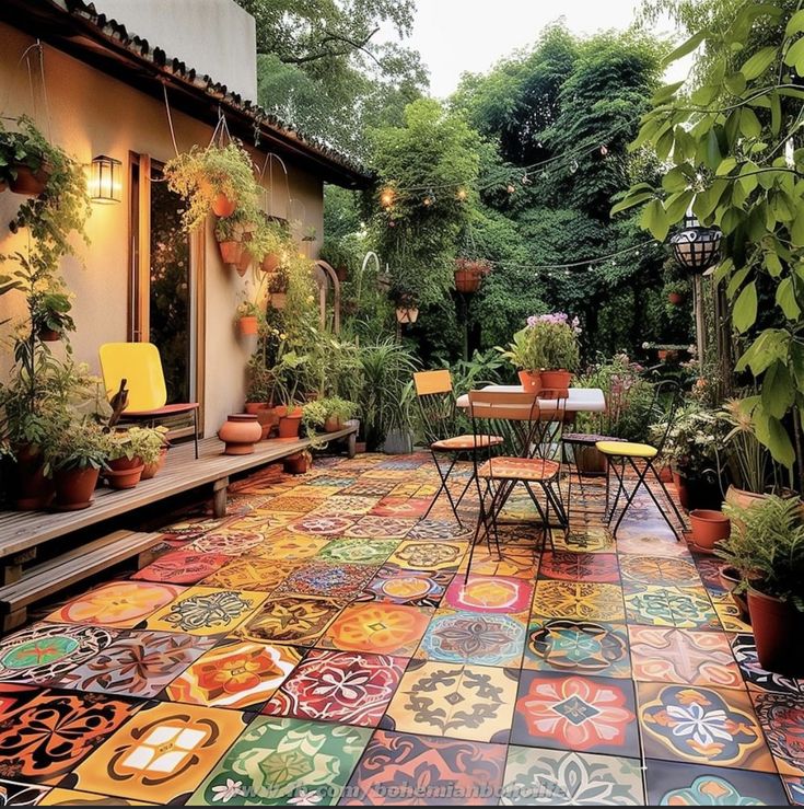 an outdoor patio with colorful tiles and potted plants