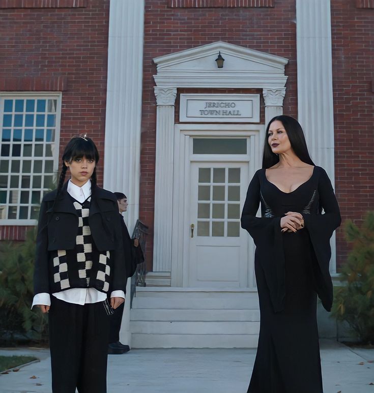 two women standing in front of a building