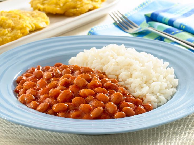 a blue plate topped with rice and beans