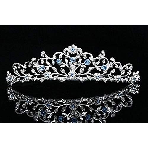 a tiara with blue and white stones is shown on a black background in this image