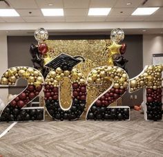 the number twenty two decorated with balloons and confetti in front of a backdrop