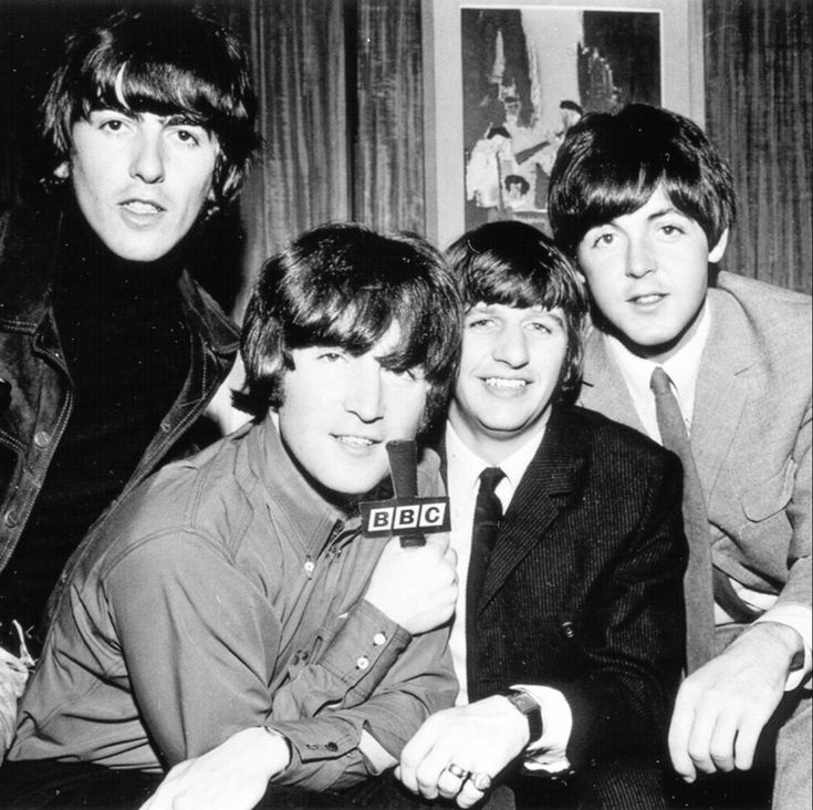 the beatles posing for a black and white photo