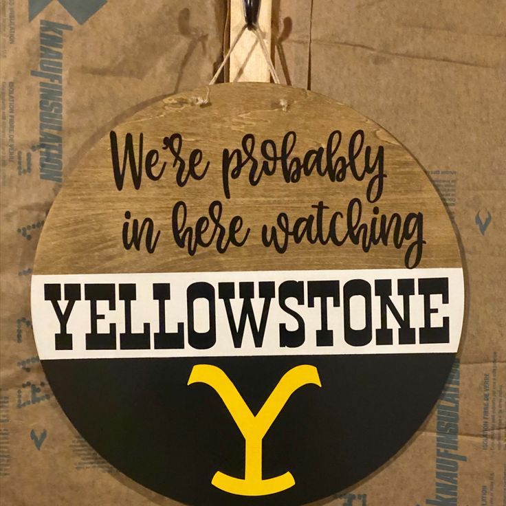 a yellow and black sign that says we're probably in here watching yellowstone