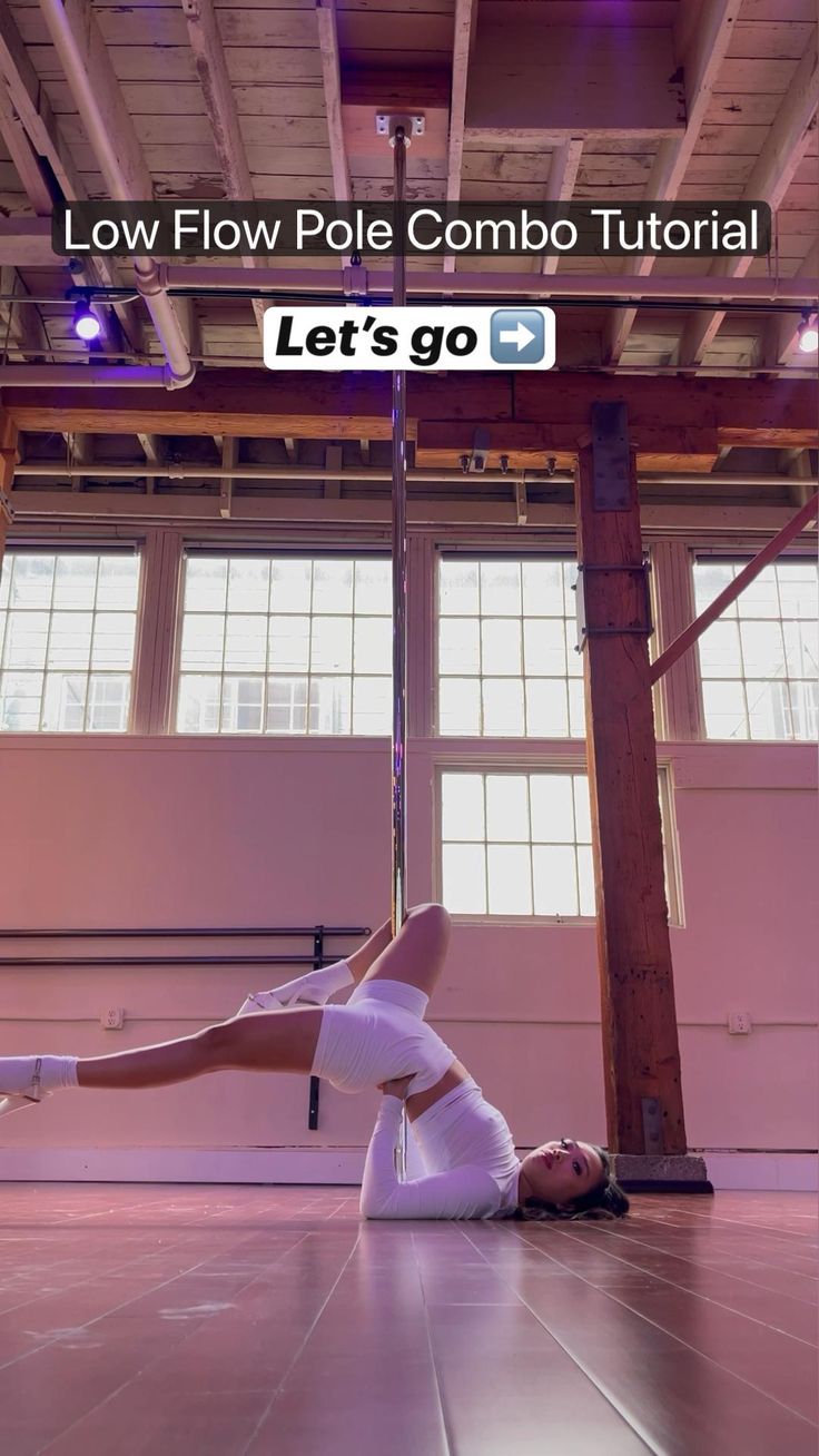 a woman in white shirt and leggings doing a handstand on the floor