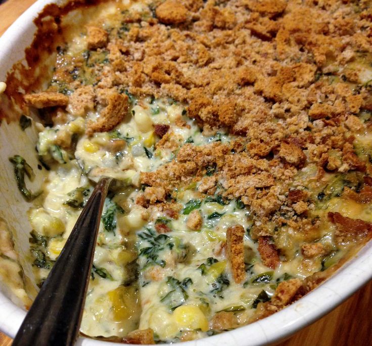 a casserole dish with cheese and spinach