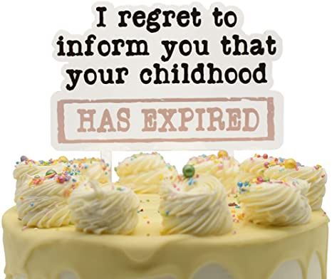 a yellow cake with white frosting and sprinkles has a sign that says i reget to inform you that your childhood has expired