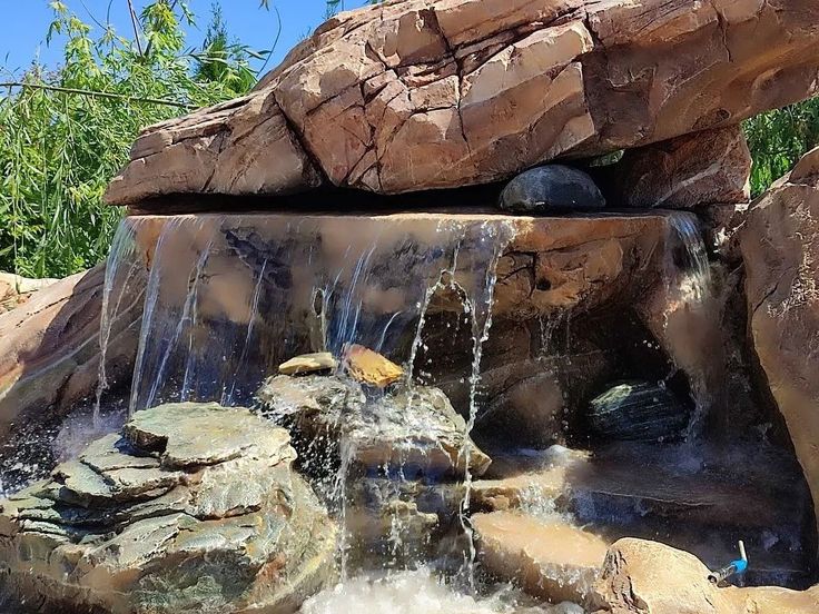 there is a waterfall in the middle of some rocks