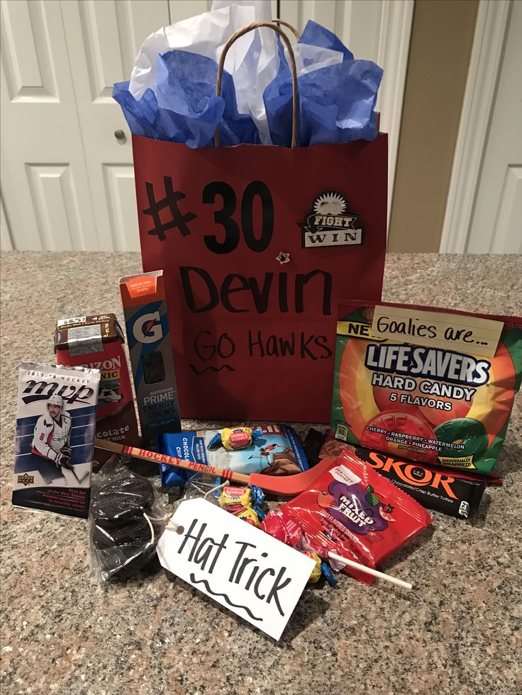 a bag full of candy and other items on a counter top with the words 30 devilin and 50 hawks written on it