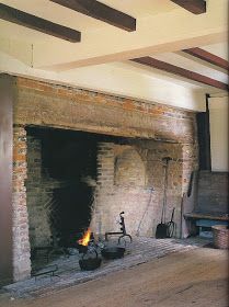 an old brick fireplace with fire in it