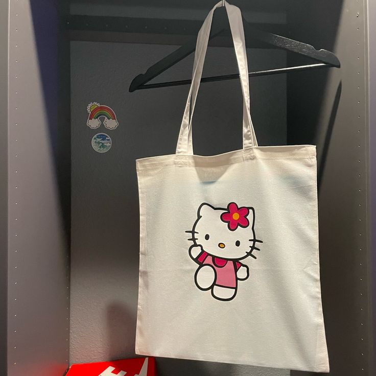 Very Adorable & Great For Carrying Everything Your Items. This Durable Canvas Tote Is Complete With An Open Design, Fixed Shoulder Straps, And Iconic Hello Kitty Graphic Logo. Hello Kitty Tote Bag, Y2k Tote Bag, Diy Tote Bag Design, Hello Kitty Tote, Tote Bag Business, Handpainted Tote Bags, Sanrio Accessories, Kitty Clothes, Hello Kitty Clothes