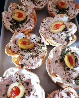 small appetizers are arranged on a metal tray