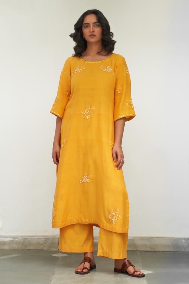 Yellow kurta with sequin, resham, mirror embroidery in floral applique pattern. Paired with pant and dupatta.
Components: 3
Pattern: Embroidery
Type Of Work: Resham, mirror, sequin, floral
Neckline: Round
Sleeve Type: Three quarter
Fabric: Mangalgiri Cotton
Color: Yellow
Other Details: 
Scallop bordered sheer dupatta
Length:
Kurta: 46 inches
Pant: 38 inches
Approx. product weight: 1-3 kg
Model height: 5ft 7inches, wearing size M
Occasion: Sangeet - Aza Fashions Cotton Silk Palazzo Set With Resham Embroidery For Festivals, Festive Cotton Silk Palazzo Set With Resham Embroidery, Festival Cotton Silk Palazzo Set With Resham Embroidery, Cotton Silk Palazzo Set With Dori Work For Festivals, Festival Cotton Silk Palazzo Set With Dori Work, Cotton Palazzo Set With Straight Kurta And Mirror Work, Festive Palazzo Set With Straight Kurta And Mirror Work, Festive Palazzo Set With Mirror Work, Festive Slub Silk Kurta With Mirror Work