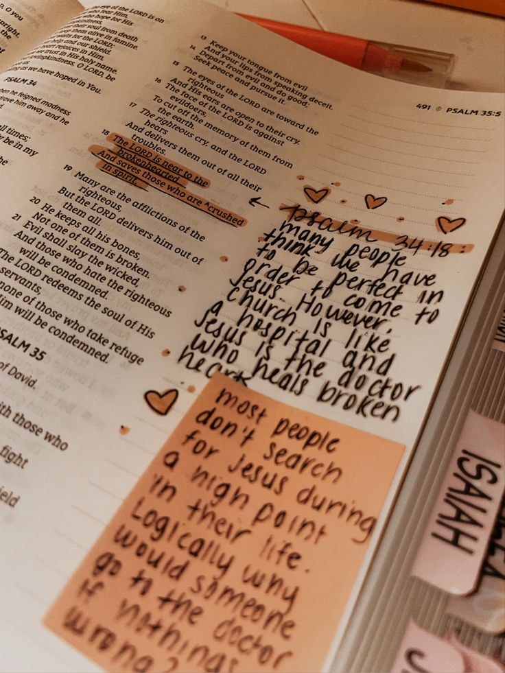 an open bible with writing on it and some stickers attached to the book's pages